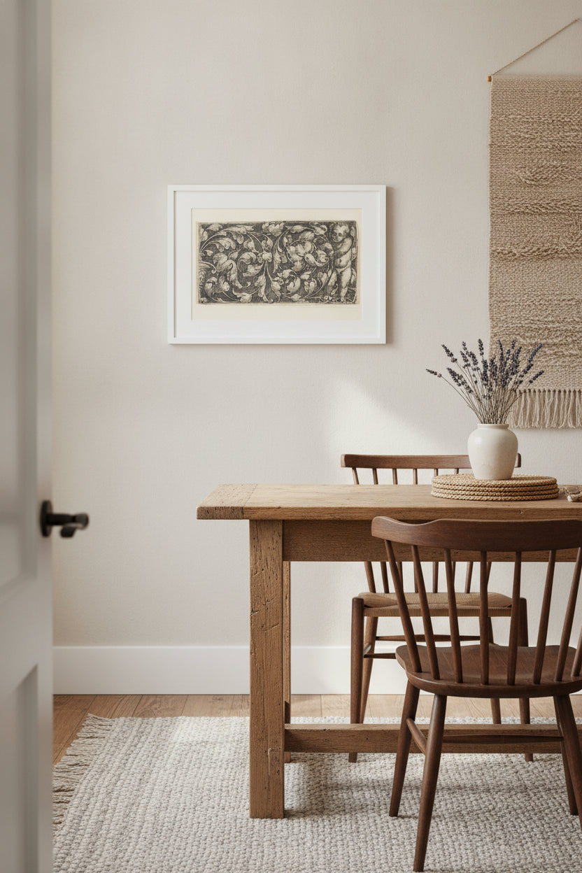 Naked Infant Holding a Double Scroll of  Leafy Ornament — framed art in a styled interior