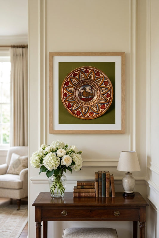 Plate with border of rounded hills within pointed arches with flowers between them; in the center, a wading bird between stylized plants — framed art in a styled interior