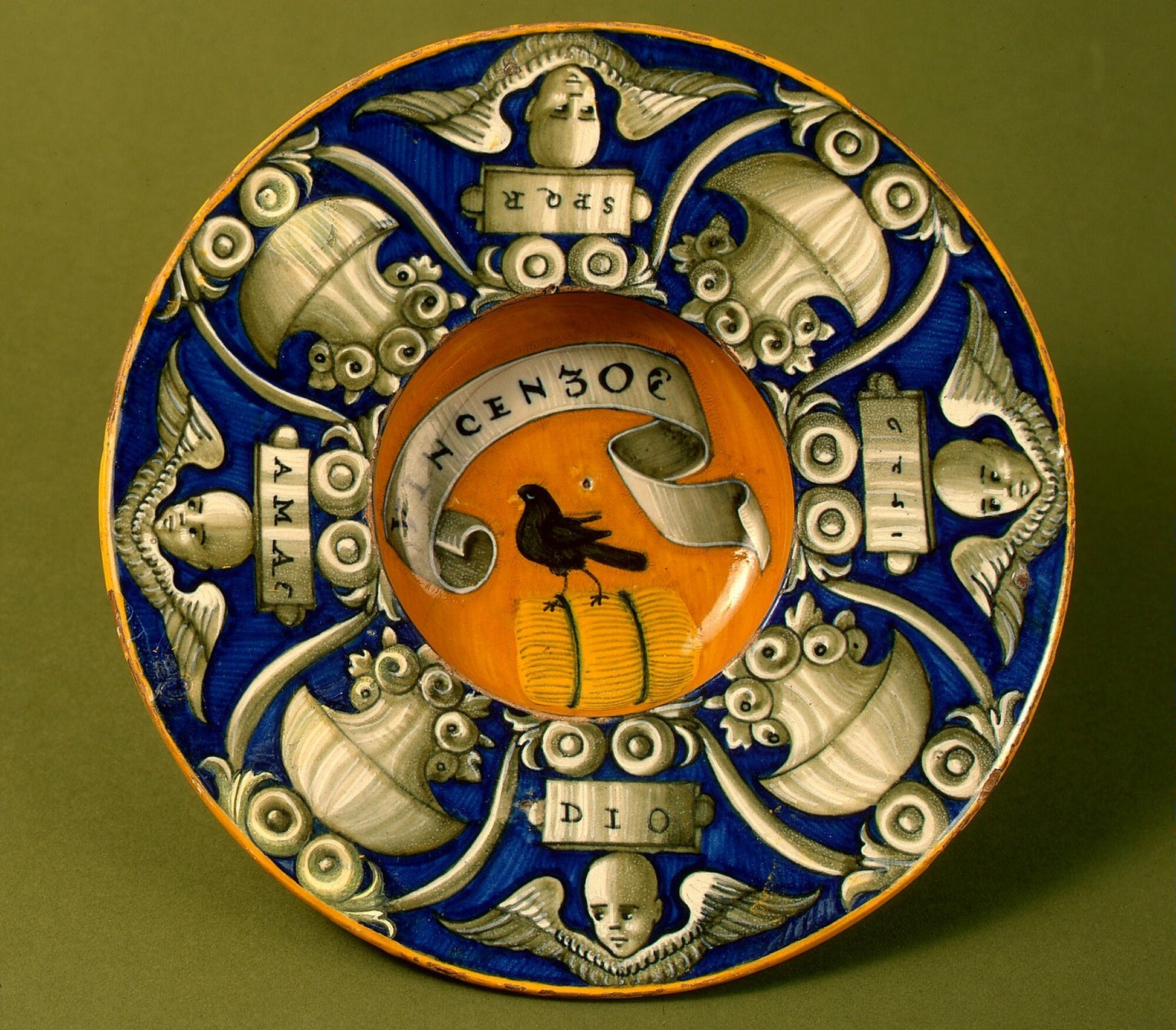 Broad-rimmed bowl with border of urns and cherubs' heads; in the center, device of a bird standing on a bundle with the inscription VINCENZO